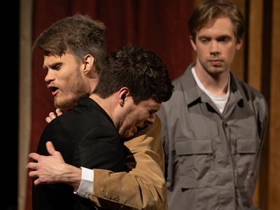 Colby Hull hugs Eli Hilliard as Justin Friesen looks on in emotional scene from "The Moon is Down." (Photo by Jared Hill, CIU Student Photographer) 